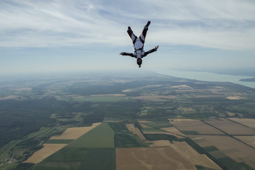 Male skydiver freeflying upside down above Siofok, Somogy, Hungary