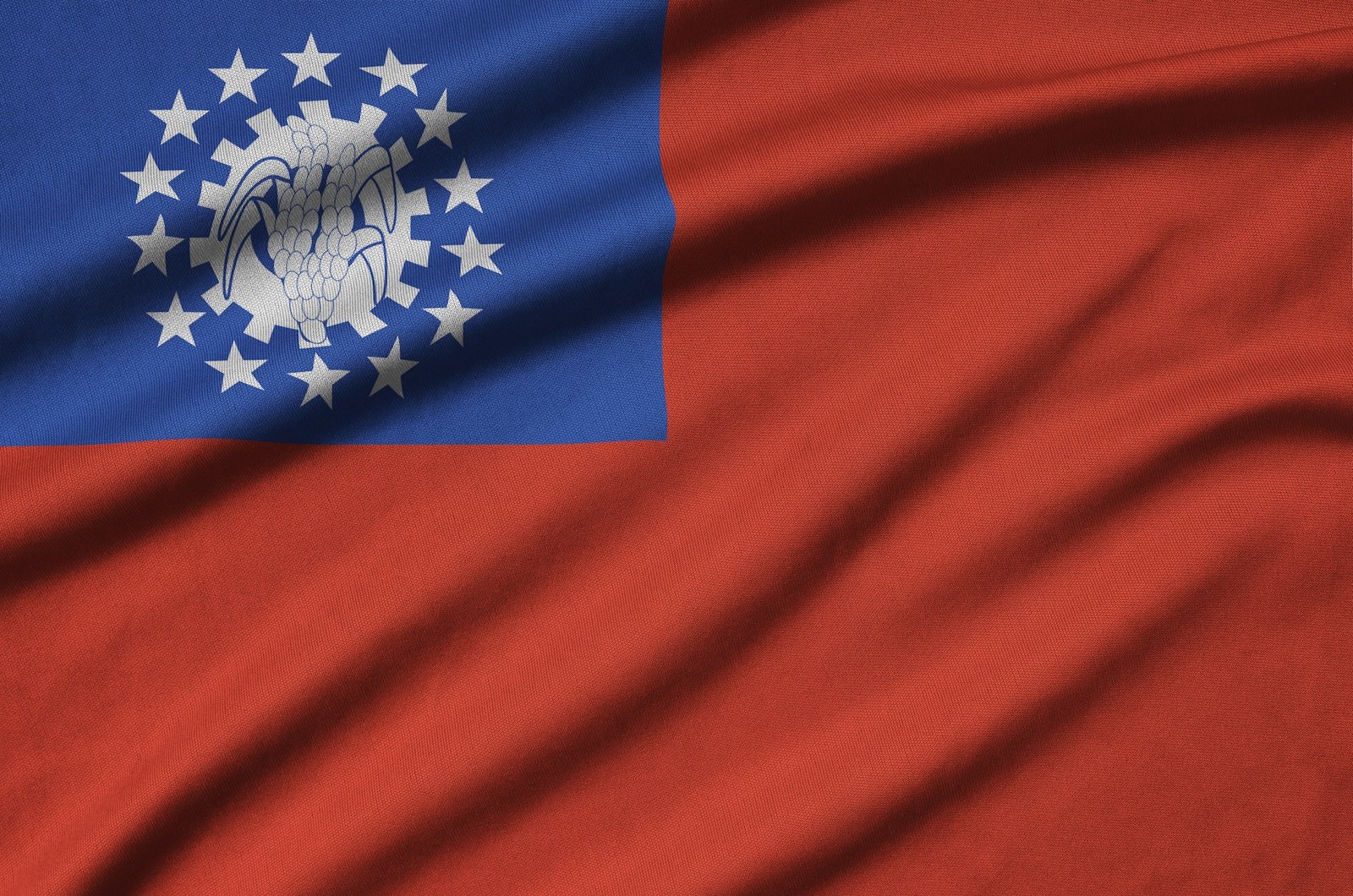 Myanmar flag is depicted on a sports cloth fabric with many folds. Sport team waving banner